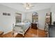 Bedroom featuring a white bed, hardwood floors and natural light from two windows at 7415 36Th E Ave, Palmetto, FL 34221