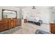 Cozy bedroom with a queen bed, dresser, a large mirror and wood-look flooring at 7415 36Th E Ave, Palmetto, FL 34221