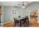 This dining room features a glass table with four chairs, hardwood floors and a ceiling fan at 7415 36Th E Ave, Palmetto, FL 34221