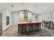 Modern kitchen featuring white cabinetry, stainless steel appliances, a central island with seating, and hardwood floors at 7415 36Th E Ave, Palmetto, FL 34221