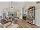 Bright living room with wood floors, high ceilings, ceiling fan, a large TV, and comfortable sofas at 7415 36Th E Ave, Palmetto, FL 34221