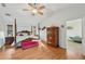 Spacious main bedroom features a four-poster bed, hardwood floors, and vaulted ceilings at 7415 36Th E Ave, Palmetto, FL 34221