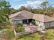 This house has a patio, a white fence, chairs and flower beds in the backyard at 7415 36Th E Ave, Palmetto, FL 34221