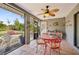 Cozy sunroom with tile floors, red table and chairs, and views of the backyard at 7415 36Th E Ave, Palmetto, FL 34221