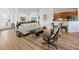 Inviting living room with wood floors, modern sofa, and view of the kitchen at 8284 Barton Farms Blvd, Sarasota, FL 34240