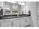 Bathroom with dual sinks, modern fixtures, and bright lighting at 8541 Coastal Palms Gln, Parrish, FL 34219