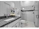 Bathroom featuring a granite countertop vanity and glass shower, providing a functional and stylish space at 8541 Coastal Palms Gln, Parrish, FL 34219