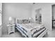 Comfortable bedroom with decorative pillows, side tables, and access to the bathroom at 8541 Coastal Palms Gln, Parrish, FL 34219