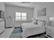 Bright bedroom with white furniture, large window, and plush bedding at 8541 Coastal Palms Gln, Parrish, FL 34219