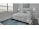 Cozy bedroom with neutral tones, area rug, and natural light from the window at 8541 Coastal Palms Gln, Parrish, FL 34219