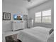 Bedroom featuring a bed, window with blinds, and decor at 8541 Coastal Palms Gln, Parrish, FL 34219