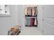 Walk-in closet with ample storage, including hanging racks and shelves for shoes and accessories at 8541 Coastal Palms Gln, Parrish, FL 34219