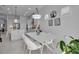 Dining area adjacent to kitchen features contemporary lighting fixtures at 8541 Coastal Palms Gln, Parrish, FL 34219