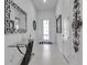 Stylish foyer with glass table, modern decor, and white tile flooring, creating a grand entrance at 8541 Coastal Palms Gln, Parrish, FL 34219