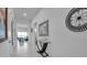 Bright hallway featuring elegant decor, white tile floors, and views of the living spaces at 8541 Coastal Palms Gln, Parrish, FL 34219