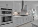 Stainless steel oven and microwave with tiled backsplash and countertop space at 8541 Coastal Palms Gln, Parrish, FL 34219