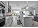 Kitchen with stainless appliances opens to the living room and dining area at 8541 Coastal Palms Gln, Parrish, FL 34219