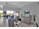 Spacious living room featuring comfortable seating, sleek furniture, and scenic outdoor views at 8541 Coastal Palms Gln, Parrish, FL 34219