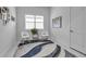 Bright, minimalist office space featuring plantation shutters, white walls, and an accent rug at 8541 Coastal Palms Gln, Parrish, FL 34219