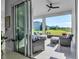 Relaxing screened patio boasts comfortable seating with view of a well-maintained lawn at 8541 Coastal Palms Gln, Parrish, FL 34219