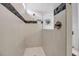 Modern shower featuring white tiling, black accents, and glass enclosure for a sleek and contemporary design at 8541 Coastal Palms Gln, Parrish, FL 34219