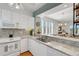 Well-equipped kitchen featuring white cabinetry, stainless steel appliances, and granite countertops at 858 Evergreen Way, Longboat Key, FL 34228