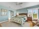 Bright main bedroom features wicker furniture and an en-suite bathroom at 858 Evergreen Way, Longboat Key, FL 34228