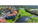 The aerial view highlights the community's lake, golf course and mature trees at 9320 Clubside Cir # 2205, Sarasota, FL 34238