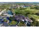 Wide angle aerial view of the community featuring the clubhouse, tennis courts, parking, and golf course at 9320 Clubside Cir # 2205, Sarasota, FL 34238