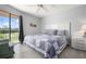 Comfortable bedroom with large bed, balcony access, and serene views at 9320 Clubside Cir # 2205, Sarasota, FL 34238