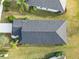 Overhead shot of dark roof, green lawn, and the landscape surrounding a well maintained residential property at 11231 Woodlake Way, Parrish, FL 34219