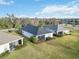 Community homes featuring screened-in lanais, manicured lawns, and a serene natural backdrop with pond and woods at 11231 Woodlake Way, Parrish, FL 34219
