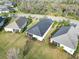 Aerial shot of homes each featuring a screened patio and bordered by manicured greenery, creating a peaceful neighborhood at 11231 Woodlake Way, Parrish, FL 34219