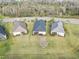 An aerial view of homes with a scenic setting with well-maintained grounds, screened patios, and road access at 11231 Woodlake Way, Parrish, FL 34219