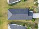 Bird's eye view of dark roof with manicured lawn and landscaping enhancing the property's curb appeal at 11231 Woodlake Way, Parrish, FL 34219