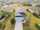 Aerial view of a well-maintained home showing landscaping, and a long driveway in a beautiful neighborhood at 11231 Woodlake Way, Parrish, FL 34219