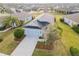 Beautiful aerial shot of a grey home with a dark roof surrounded by greenery and neighborhood homes at 11231 Woodlake Way, Parrish, FL 34219