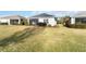 Well-maintained backyard with lush green grass, a cozy screened lanai, and neat landscaping at 11231 Woodlake Way, Parrish, FL 34219