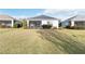 Well-maintained backyard featuring a cozy screened lanai, lush grass, and beautiful landscaping at 11231 Woodlake Way, Parrish, FL 34219