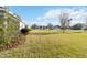 Expansive backyard featuring mature landscaping, green grass, and a view of neighboring homes at 11231 Woodlake Way, Parrish, FL 34219