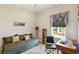 Neutral bedroom features a daybed with a desk, and a view to the outdoors at 11231 Woodlake Way, Parrish, FL 34219