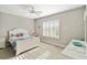 Cozy bedroom features soft natural light, comfortable bed, and neutral decor at 11231 Woodlake Way, Parrish, FL 34219