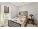 Cozy bedroom features a neutral color scheme and a window with white sheer curtains at 11231 Woodlake Way, Parrish, FL 34219
