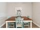 Charming dining area features a wooden table, turquoise chairs, and tile flooring at 11231 Woodlake Way, Parrish, FL 34219