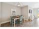 Charming dining area features a wooden table, turquoise chairs, and tile flooring at 11231 Woodlake Way, Parrish, FL 34219