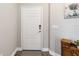 Clean entryway with a neutral color scheme, decorative rug, and stylish, secure white front door at 11231 Woodlake Way, Parrish, FL 34219