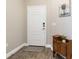 Clean entryway with a neutral color scheme, decorative rug, and stylish, secure white front door at 11231 Woodlake Way, Parrish, FL 34219
