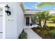 Welcoming front porch with a bench, well-kept garden, and a clear view of the home's address at 11231 Woodlake Way, Parrish, FL 34219