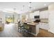 Open-concept kitchen features bar seating, stainless steel appliances, and an open living space at 11231 Woodlake Way, Parrish, FL 34219