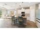 Open-concept kitchen featuring white cabinetry, granite counters, and stainless steel appliances with living space view at 11231 Woodlake Way, Parrish, FL 34219
